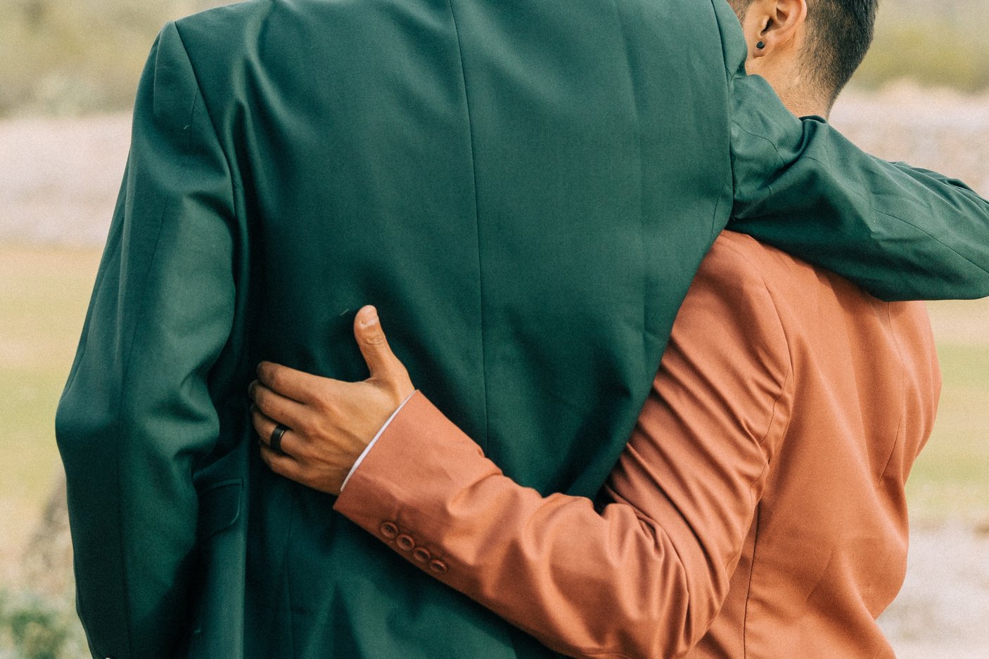 Newlywed Couple Wrapping Their Arms Around Each Other
